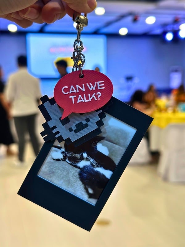 Instax frame keychain held up at an event